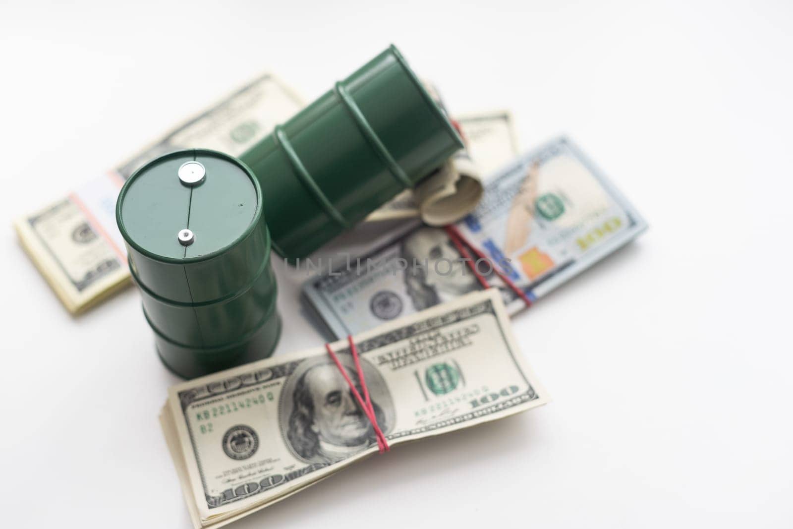 barrels of oil standing on the dollar bills of money. the oil business, purchase sale, production, exchange, trading income. High quality photo