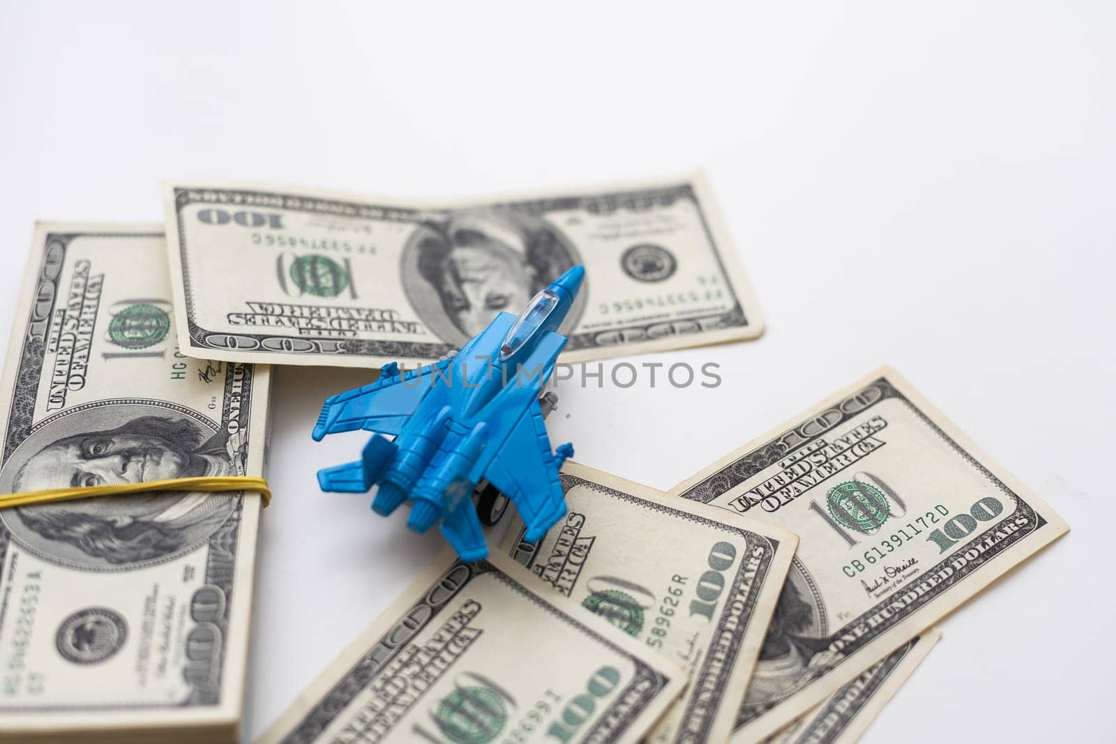 Toy plane and money on background. Travel insurance by Andelov13