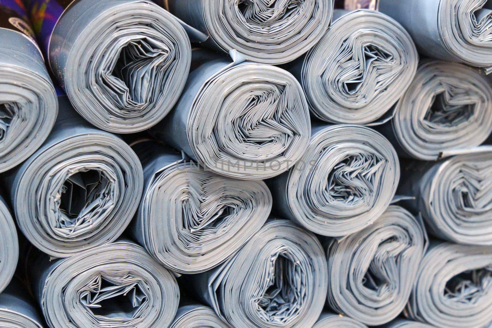 Gray Plastic rolls stacked in a disorderly manner, creating a sound of roller paper