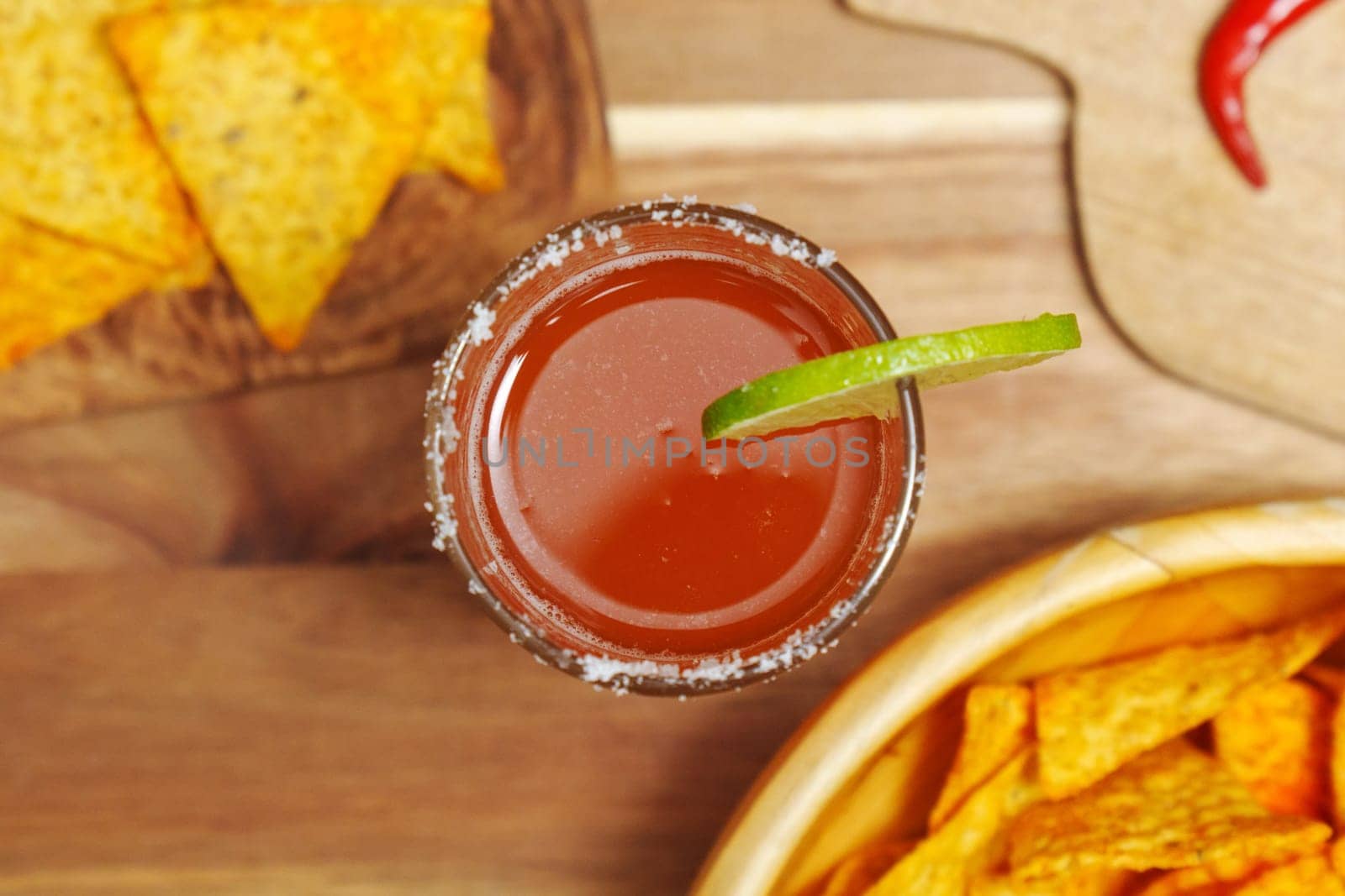 Michelada, Mexican alcoholic cocktail with beer, lime juice, tomato juice by darksoul72