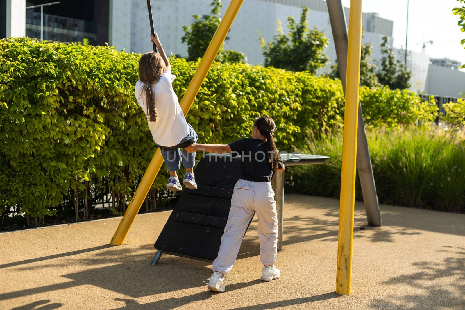 Girl playing on a swing in the park. High quality photo