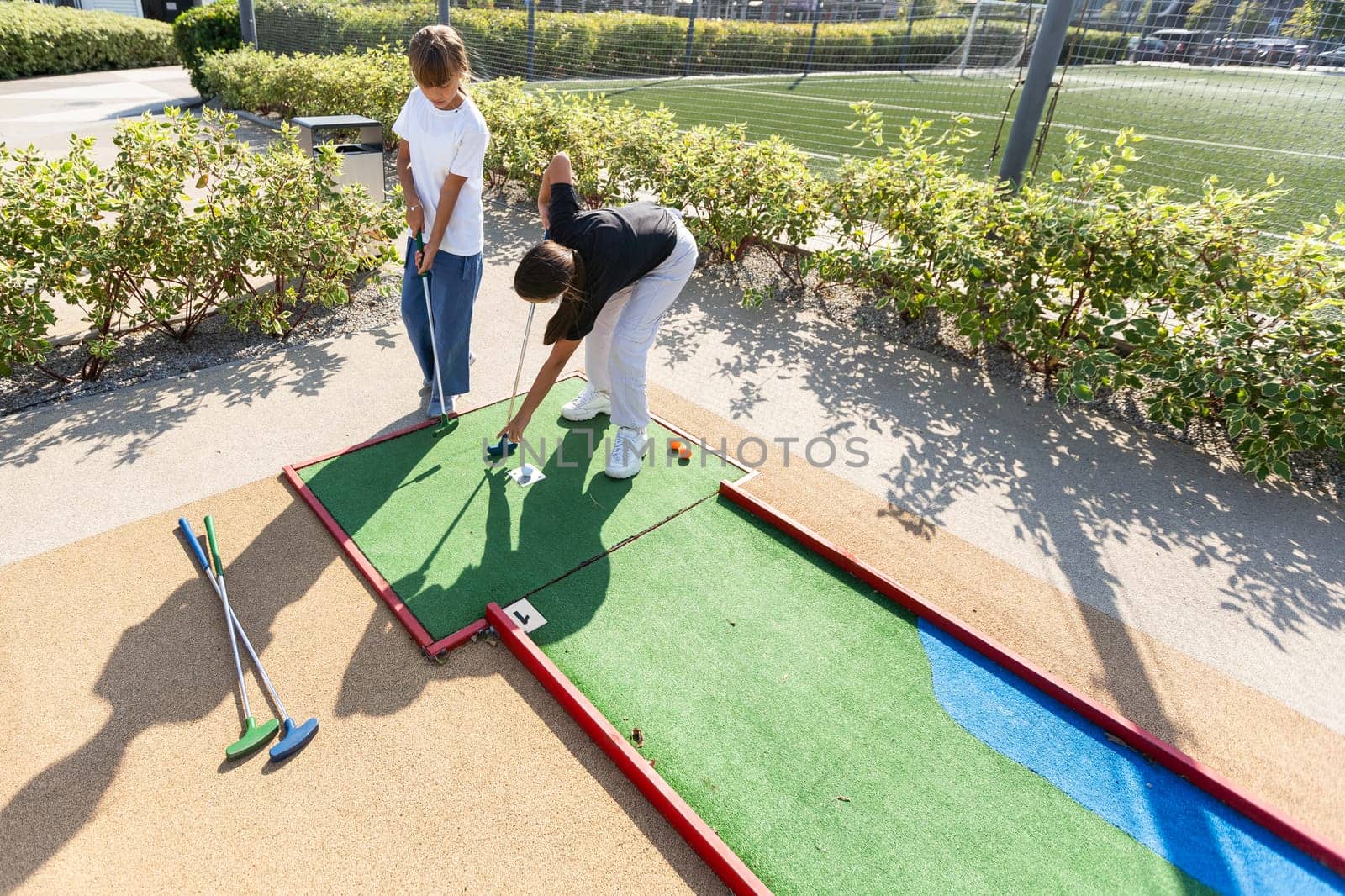 Cute little girl playing golf. High quality photo