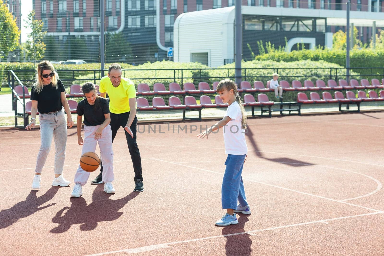 family playing basketball on court. High quality photo