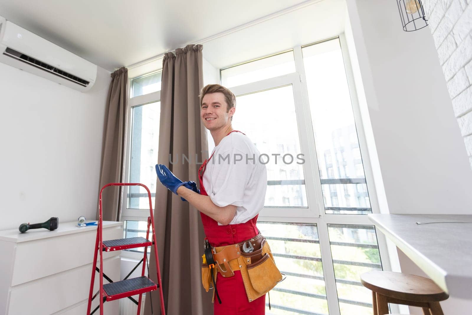 the worker connecting a new air conditioner unit.