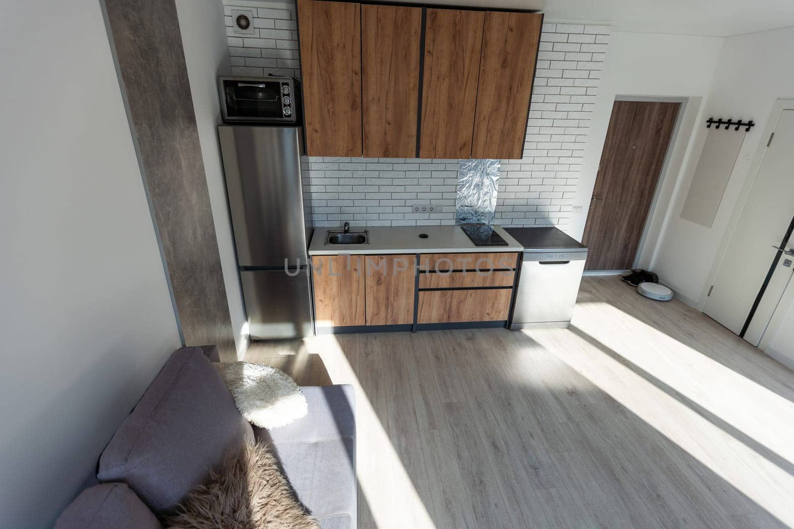 Modern living room and kitchen in small apartment.