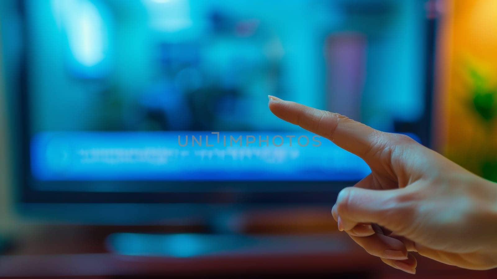 A person pointing at a television with their finger