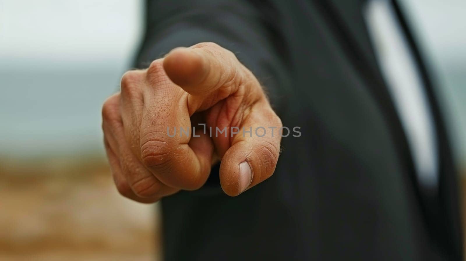 A man in a suit pointing at something with his finger