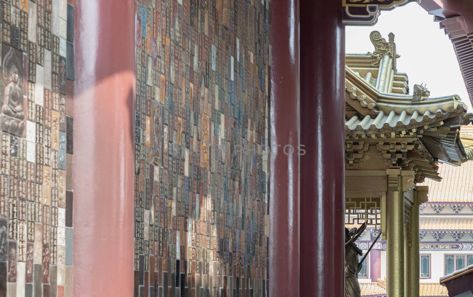 Bangkok, Thailand - Apr 11, 2024 - Golden gable roof and slab of colored tiles on temple wall at Fo Guang Shan Thaihua Temple. Architecture exterior of Taiwanese temple style, Space for text, Selective focus.