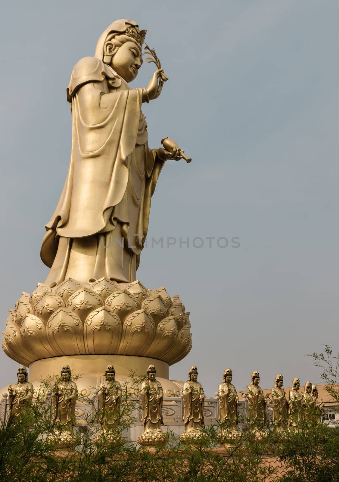 Bangkok, Thailand - Apr 11, 2024 - Big Golden statue goddess of Mercy Guanyin or Quan Yin statue at Fo Guang Shan Thaihua Temple. Guan Yin Buddha, Taiwanese temple style, Space for text, Selective focus.