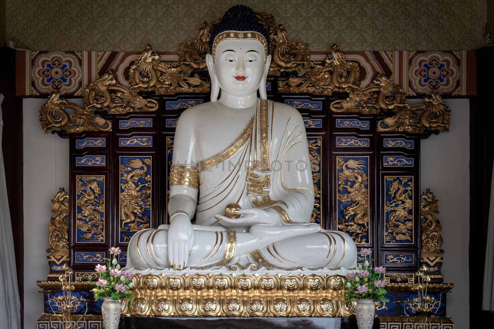 Bangkok, Thailand - Apr 11, 2024 - White Gautama Buddha Statue Sitting on Lotus. The Shakyamuni Meditating Buddha at Fo Guang Shan Thaihua Temple, Copy space, Selective focus.