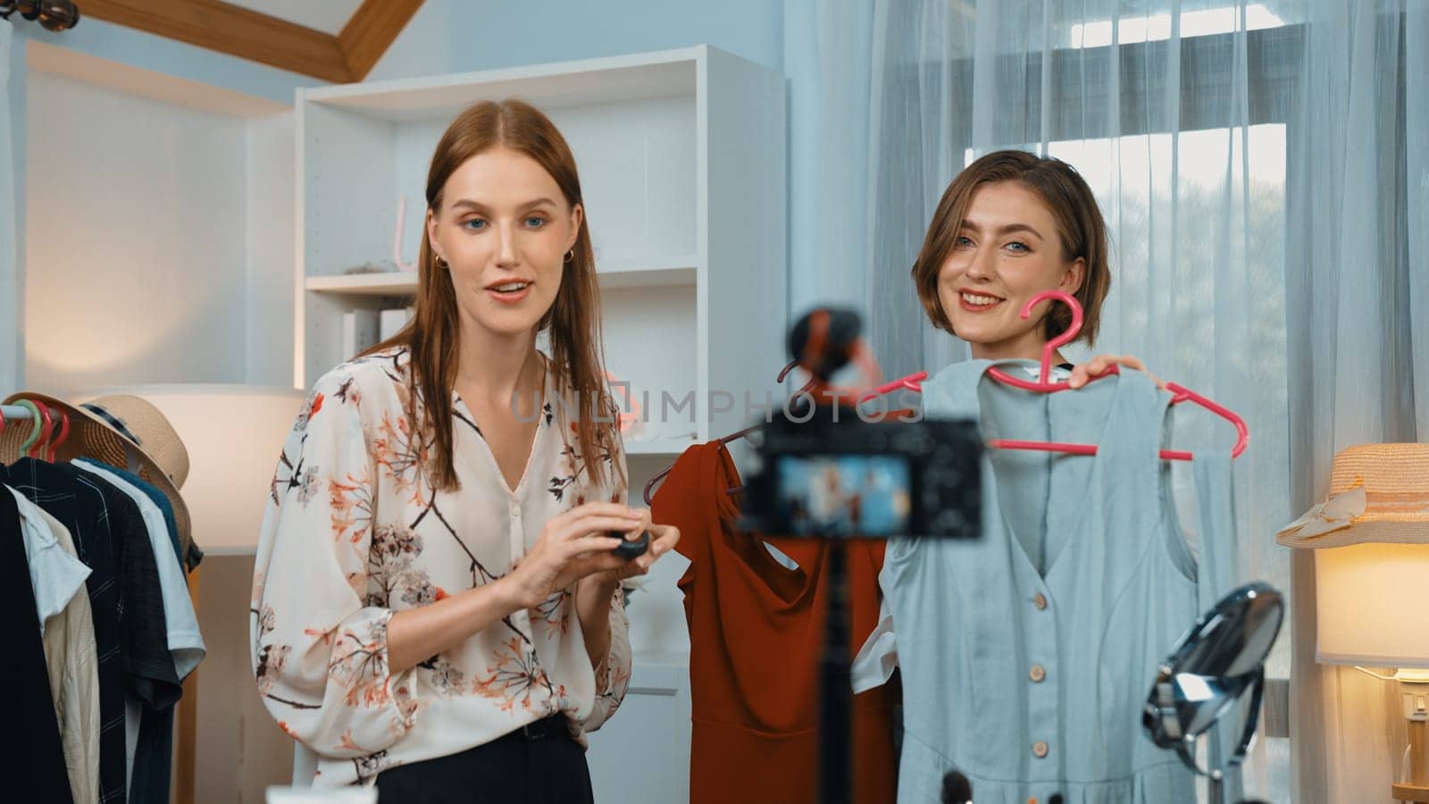 Two women influencer shoot live streaming review clothes prim social media by biancoblue