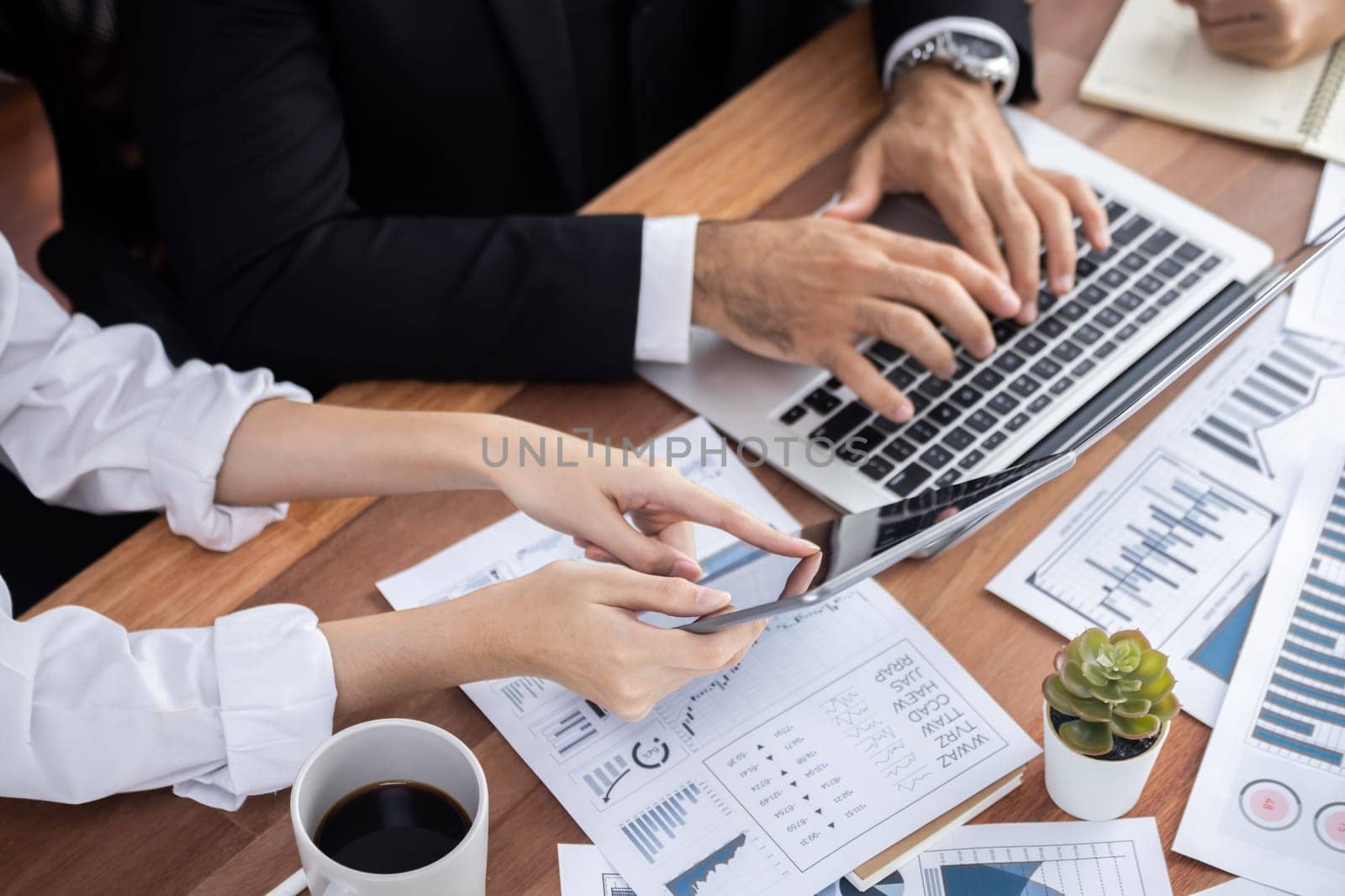 Diverse group of business analyst team analyzing financial data report paper on office table. Chart and graph dashboard by business intelligence analysis for strategic marketing planning Meticulous