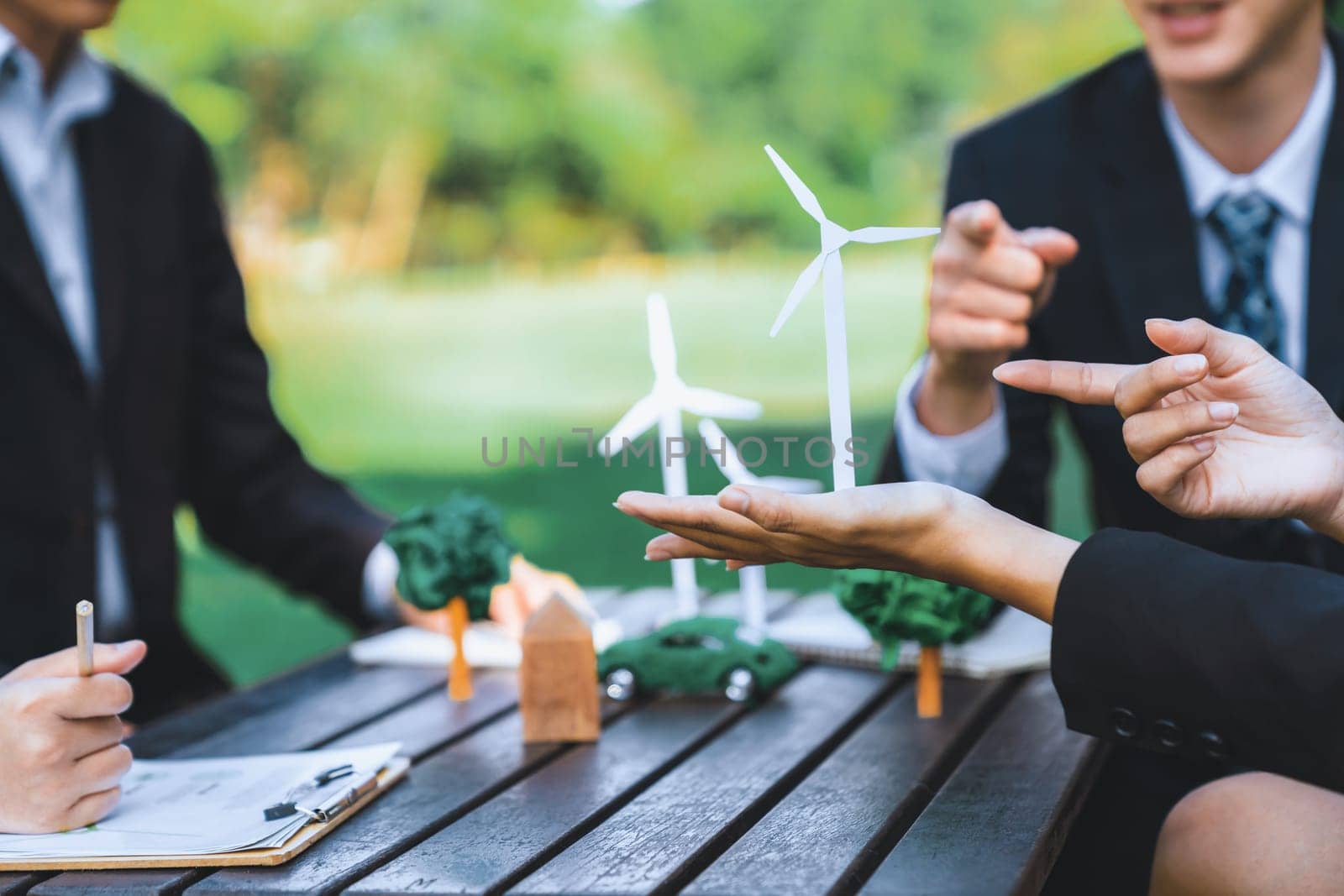 Group of asian business people presenting environmentally friendly development plan and sustainable technology project for greener future, establishing outdoor eco business office at natural park.Gyre