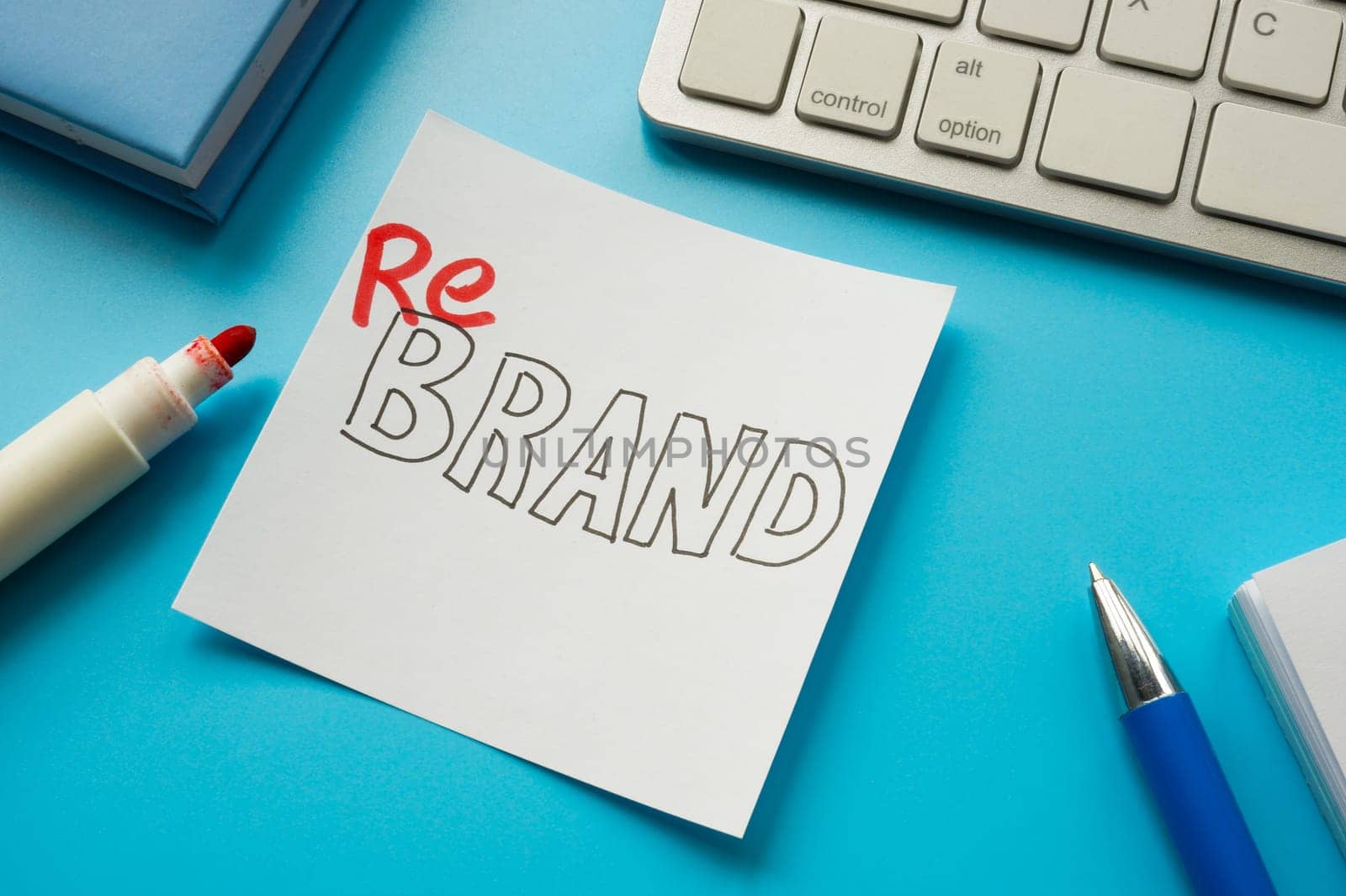 The word rebrand written with a marker on a white sticker. by designer491