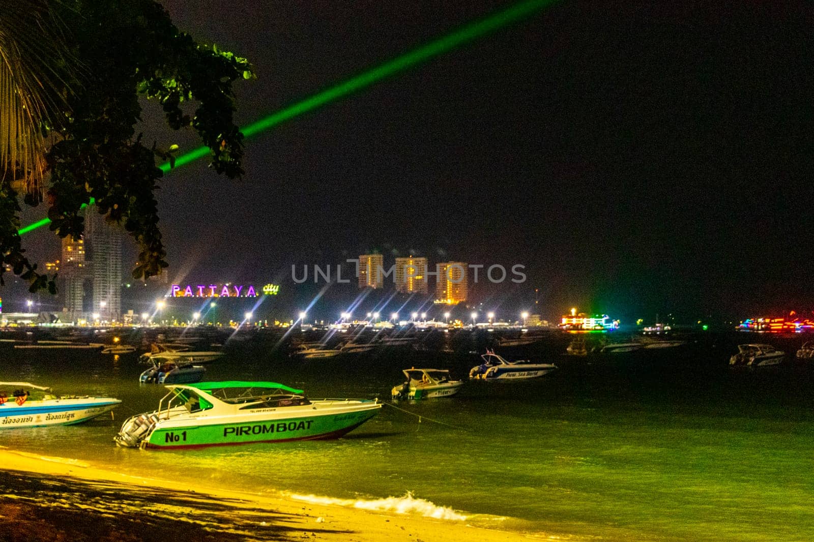Colorful city Pattaya sign name lettering lights at night Thailand. by Arkadij