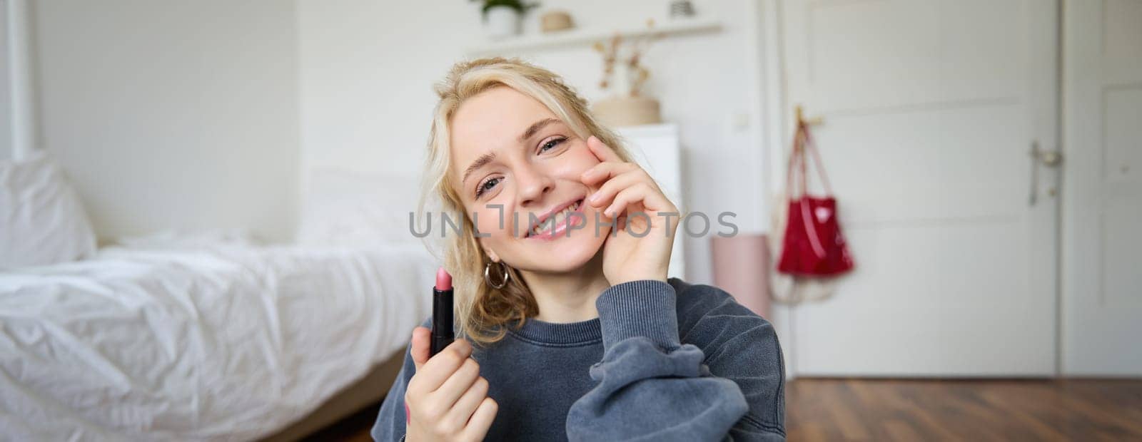 Portrait of young beautiful woman recording video blog in her room, lifestyle beauty content for social media, talking in front of camera, live stream chatting online with followers.