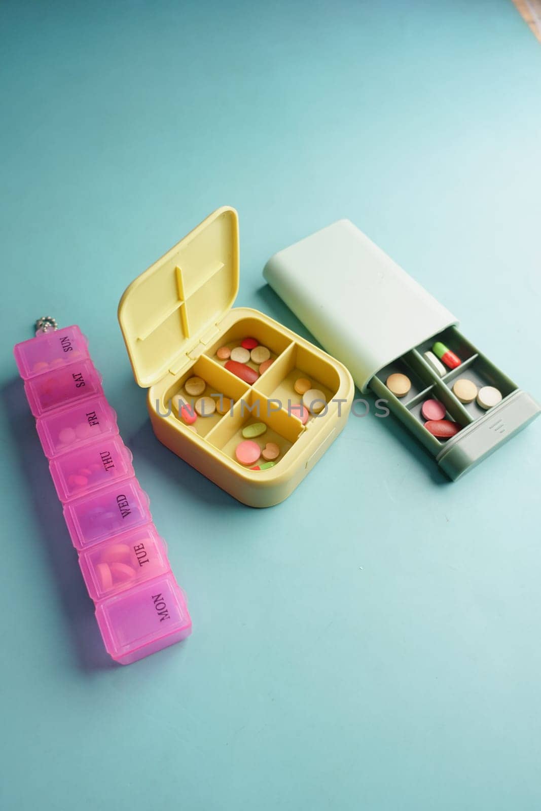 close up of medical pills in a pill box on table .