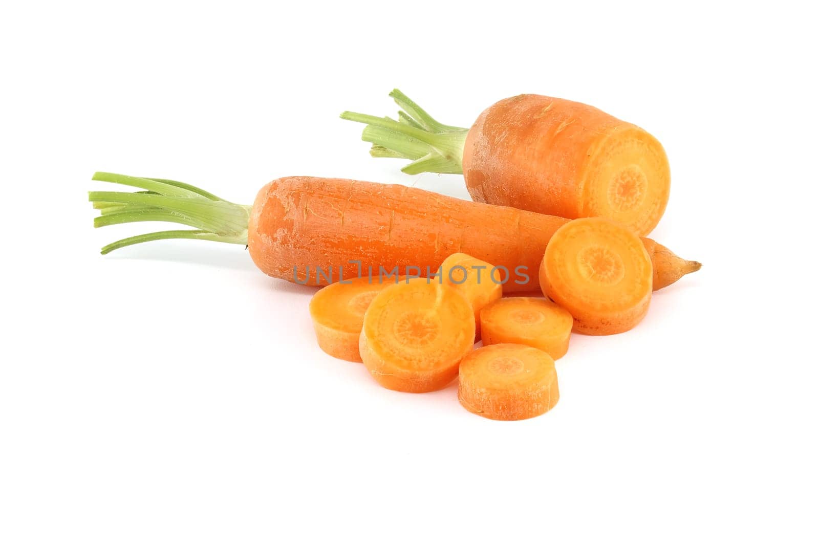 Whole carrot and its sliced pieces isolated against a white background by NetPix