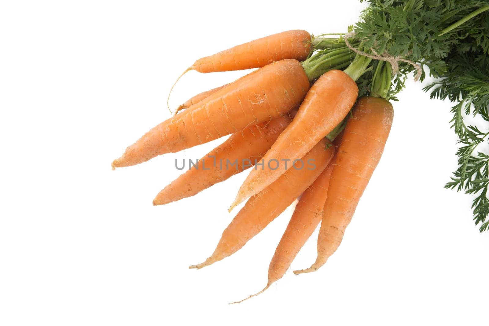 Bundle of fresh, orange carrots with green tops isolated on white by NetPix