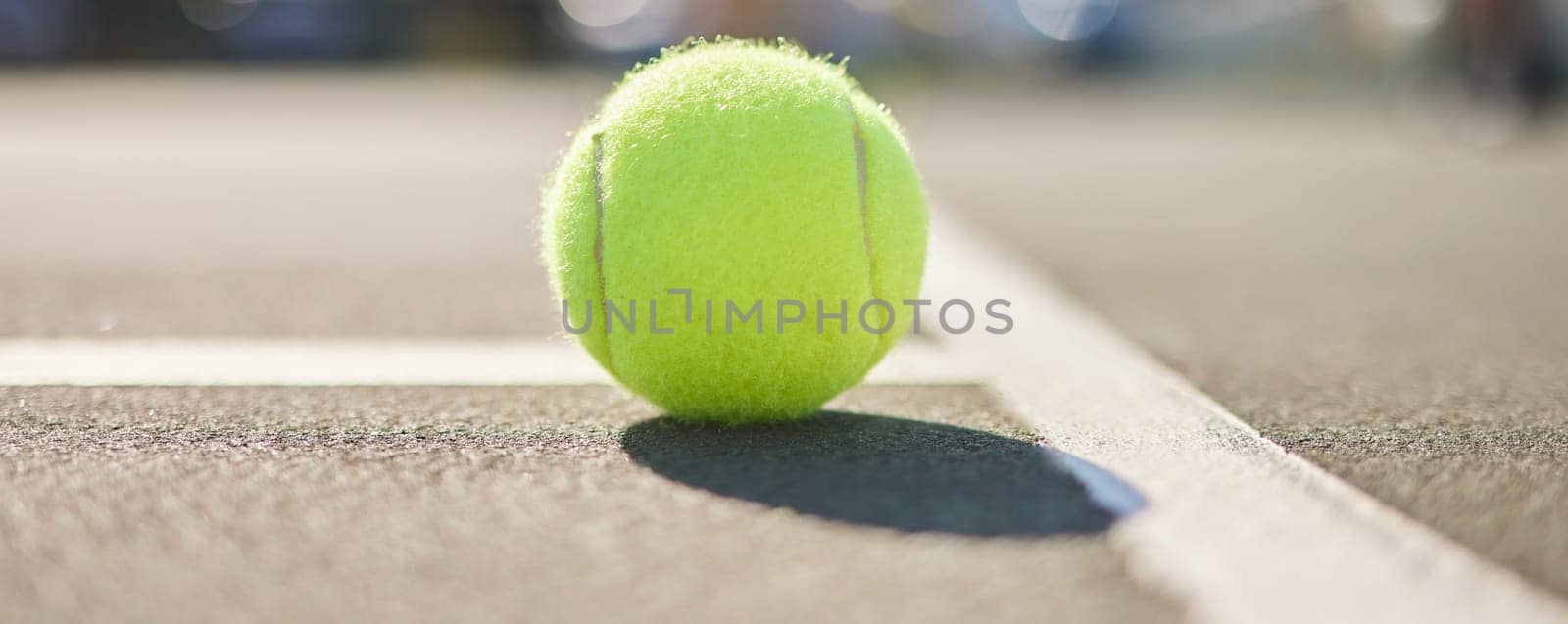 Tennis court, ball and fitness outdoor on asphalt and ground with sport, workout and competition equipment. Training, turf and exercise with shadow of game gear ready for a match and serve in sun.