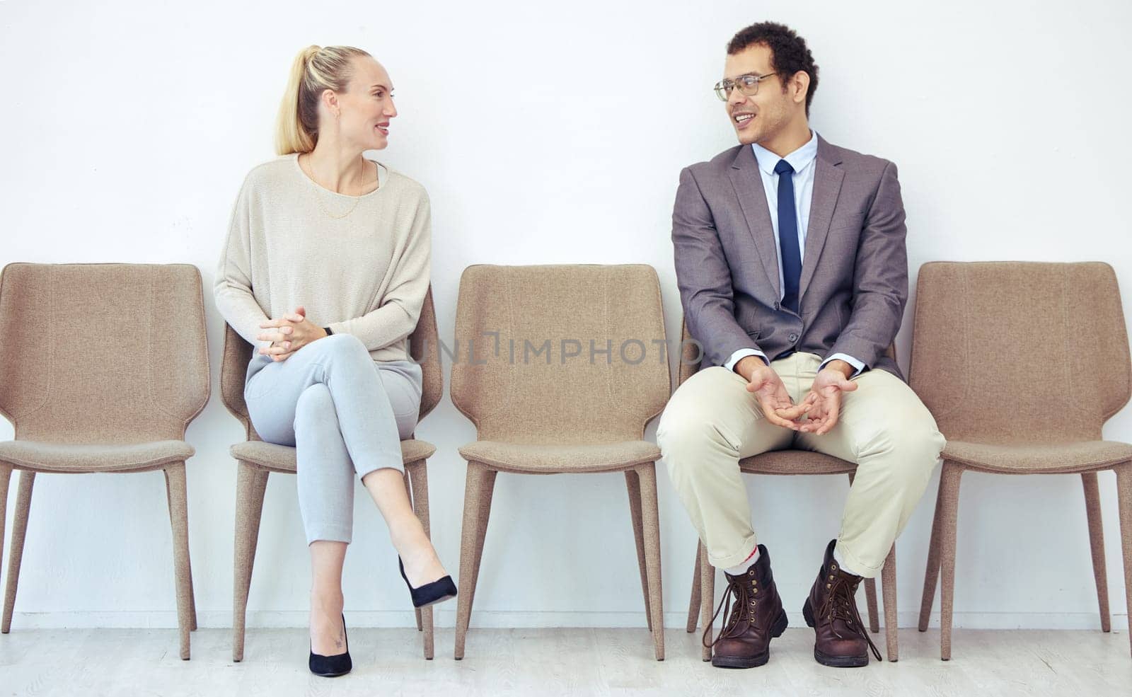 Conversation, row and people for business interview and waiting for meeting with hr, communication and talking. Man, woman and sitting for recruitment or hiring by corporate company and appointment