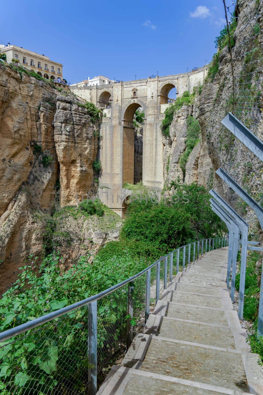 ronda ,malaga, spain 04/18/2023 path that goes down to the base of the new bridge of ronda over the cliffs