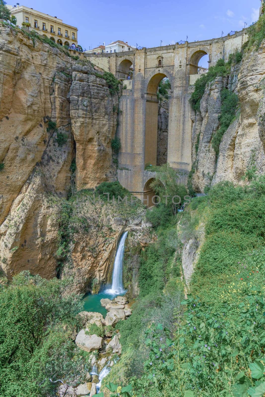 ronda ,malaga, spain 04/18/2023 new bridge over the cliff with a waterfall of the river guadalevin