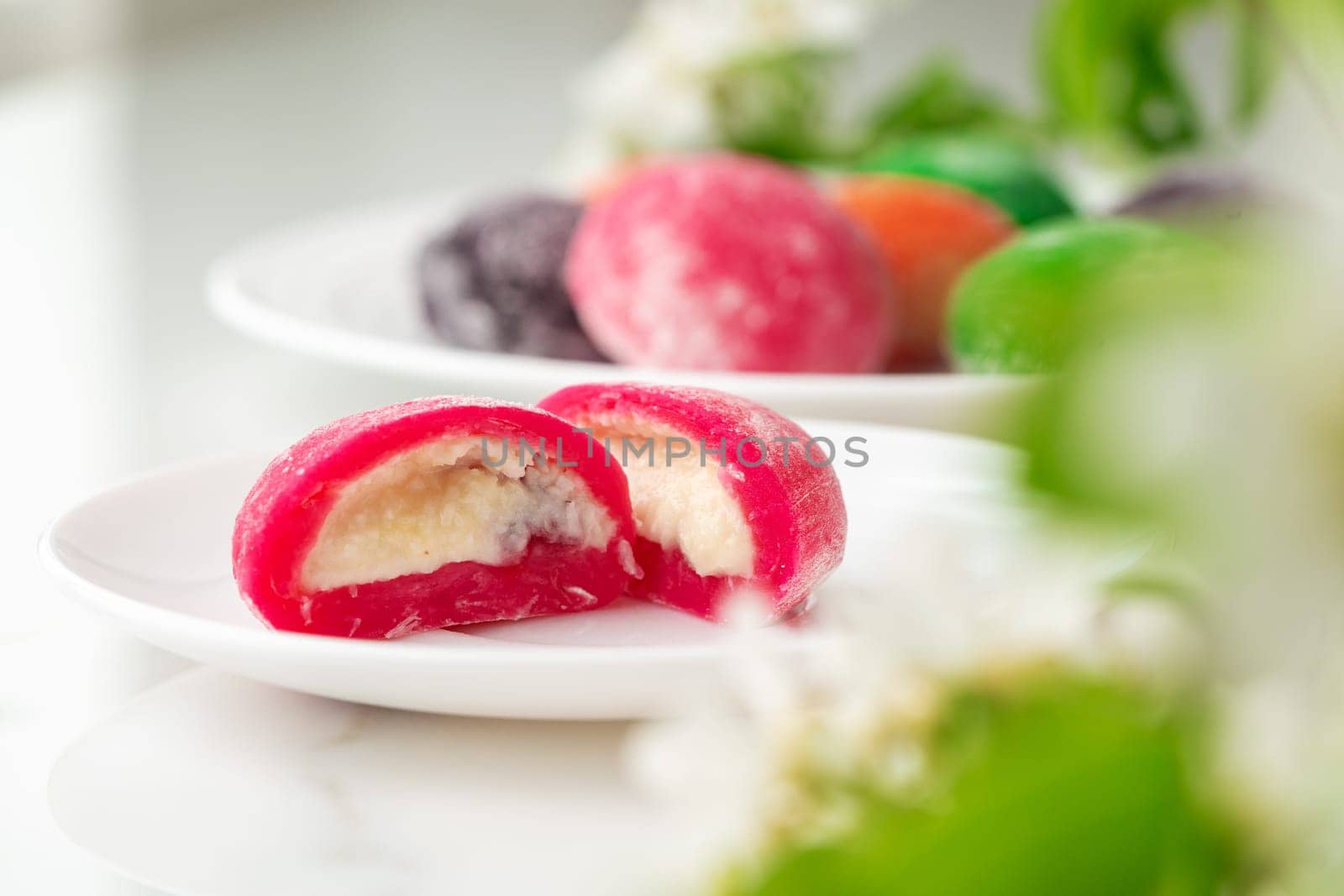 Multi-colored Japanese cakes Mochi in a white plate close up