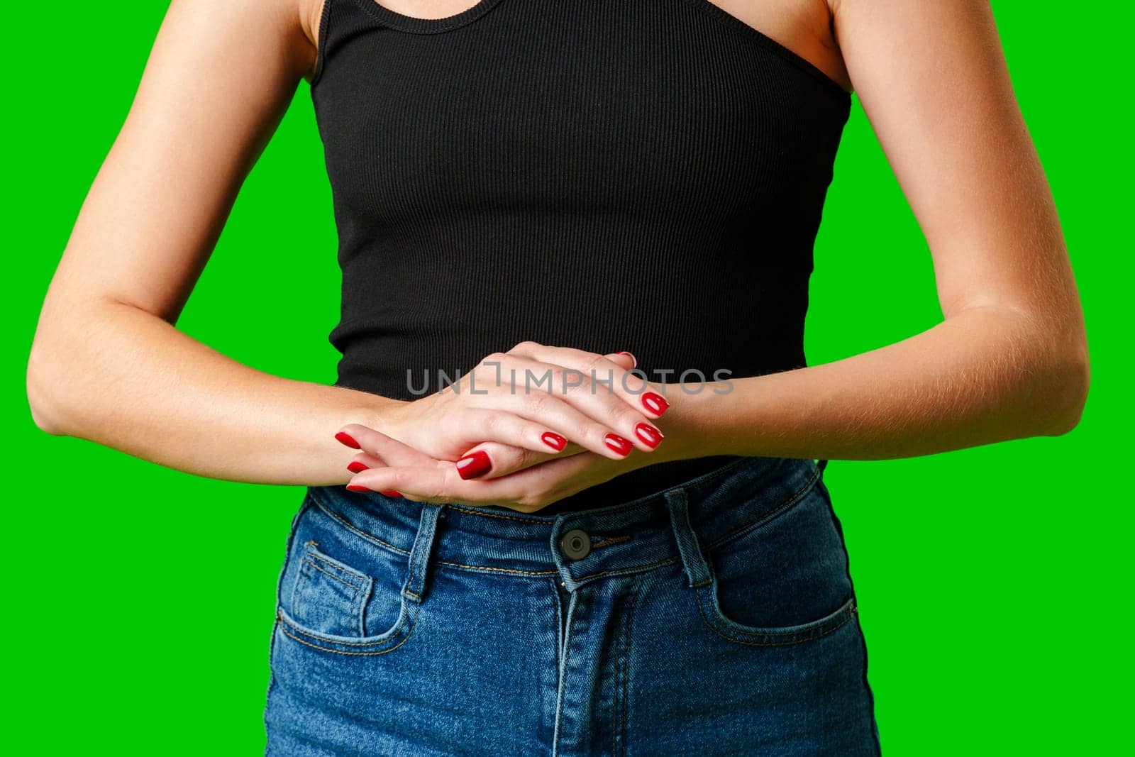 Woman in Black Tank Top Holding Hands Together against green background