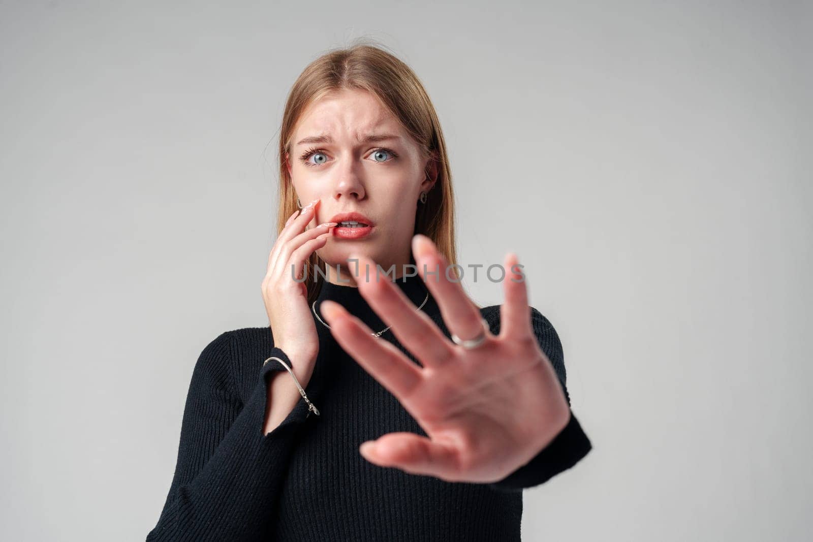 Young Woman Expressing Discomfort and Disapproval With Hands Up in Studio close up