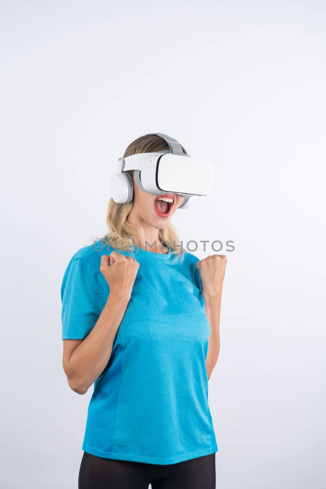 Caucasian happy girl making winner gesture while using VR glasses. Contraption. by biancoblue