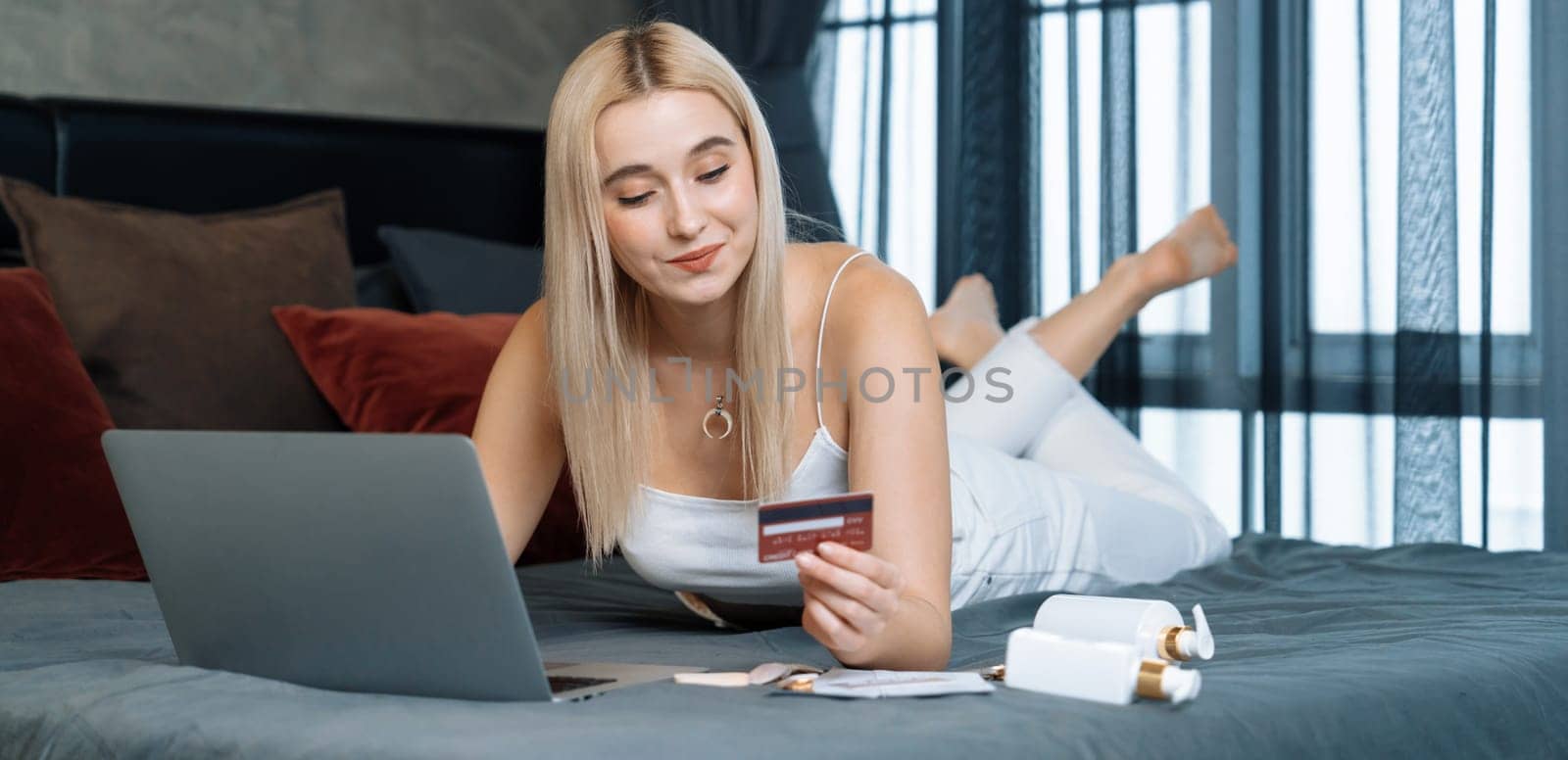 Young woman using laptop with credit card for internet banking, online shopping E commerce by online payment gateway at home office. Modern and convenience online purchase. Panorama Blithe