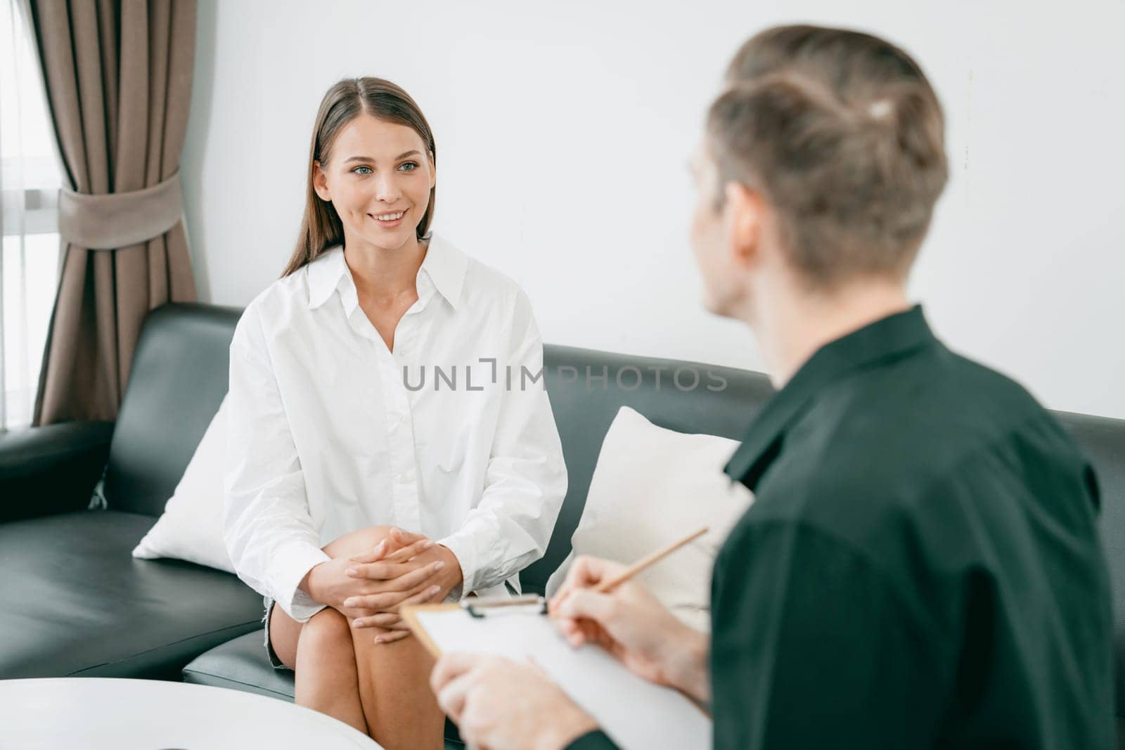 Psychological consultation gaining improvement on mental problem, happy young female patient doing therapy session while psychiatrist making diagnostic on mental illness. Unveiling