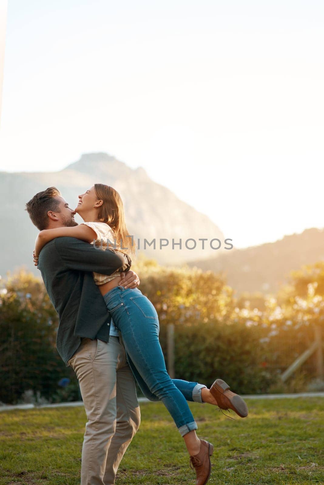 Happy couple, hug and laughing in park for marriage anniversary or funny joke, love or romance. Man, woman and pick up with embrace in backyard for partnership travel on date, vacation or summer by YuriArcurs
