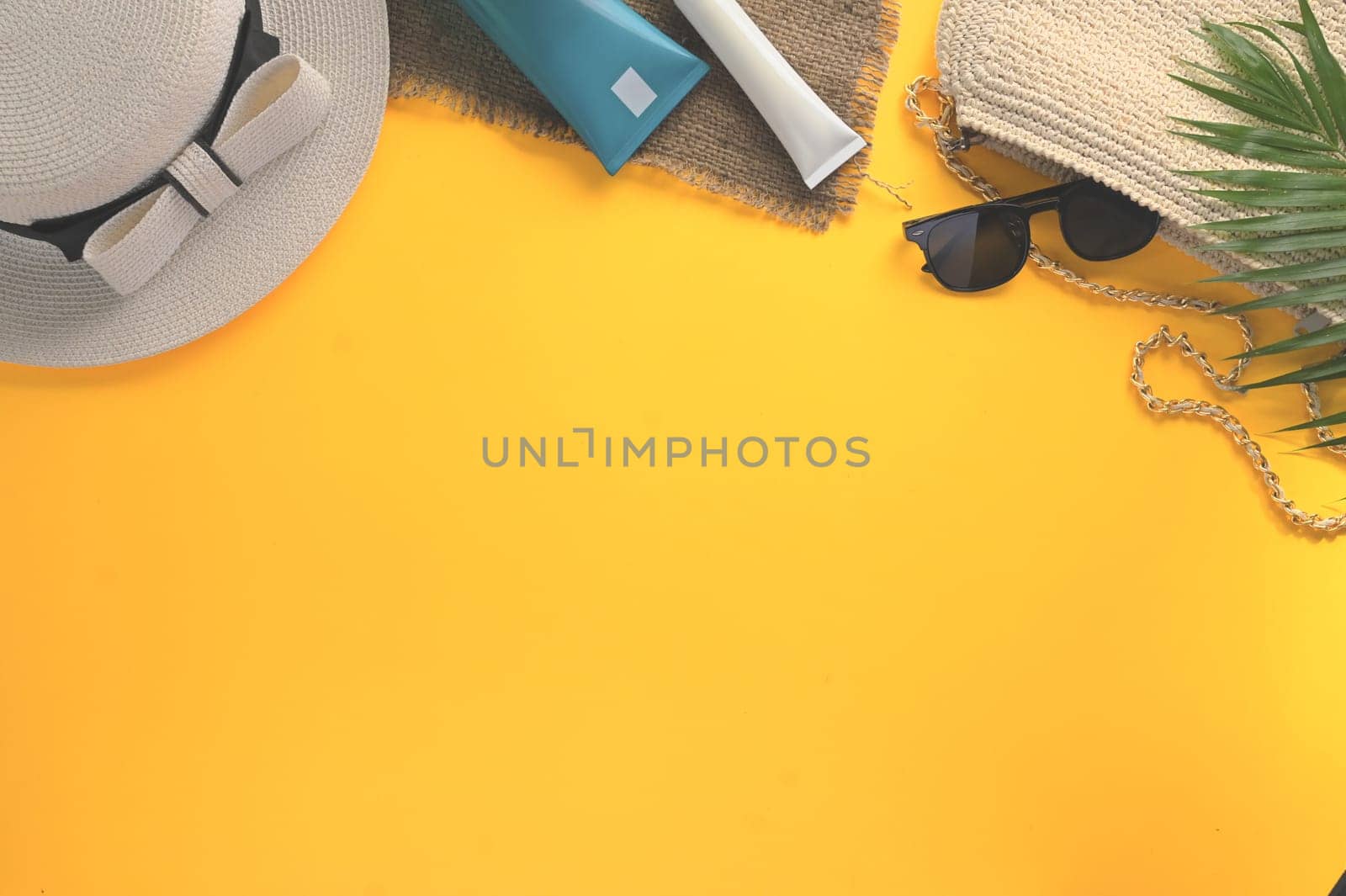 Top view traveler accessories on yellow background. Summer and travel vacation concept.