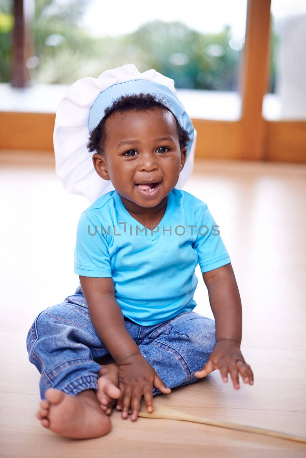Black baby, portrait and chefs hat in house on floor for kids youth, playing and fun. African child, happy and smile in home in living room with toque for recreation, memories and family bonding by YuriArcurs