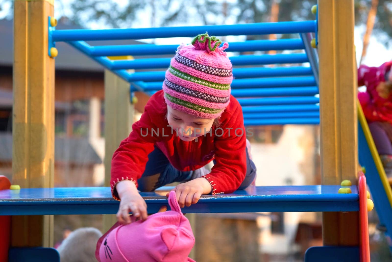 Cute child playing on the ladder at the playground by jovani68