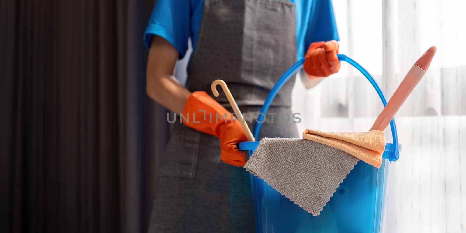 Cleaning product, and basket with woman staff cleaning service in bedroom to clean bacteria at apartment. cleaner or maid with container to work in room by nateemee