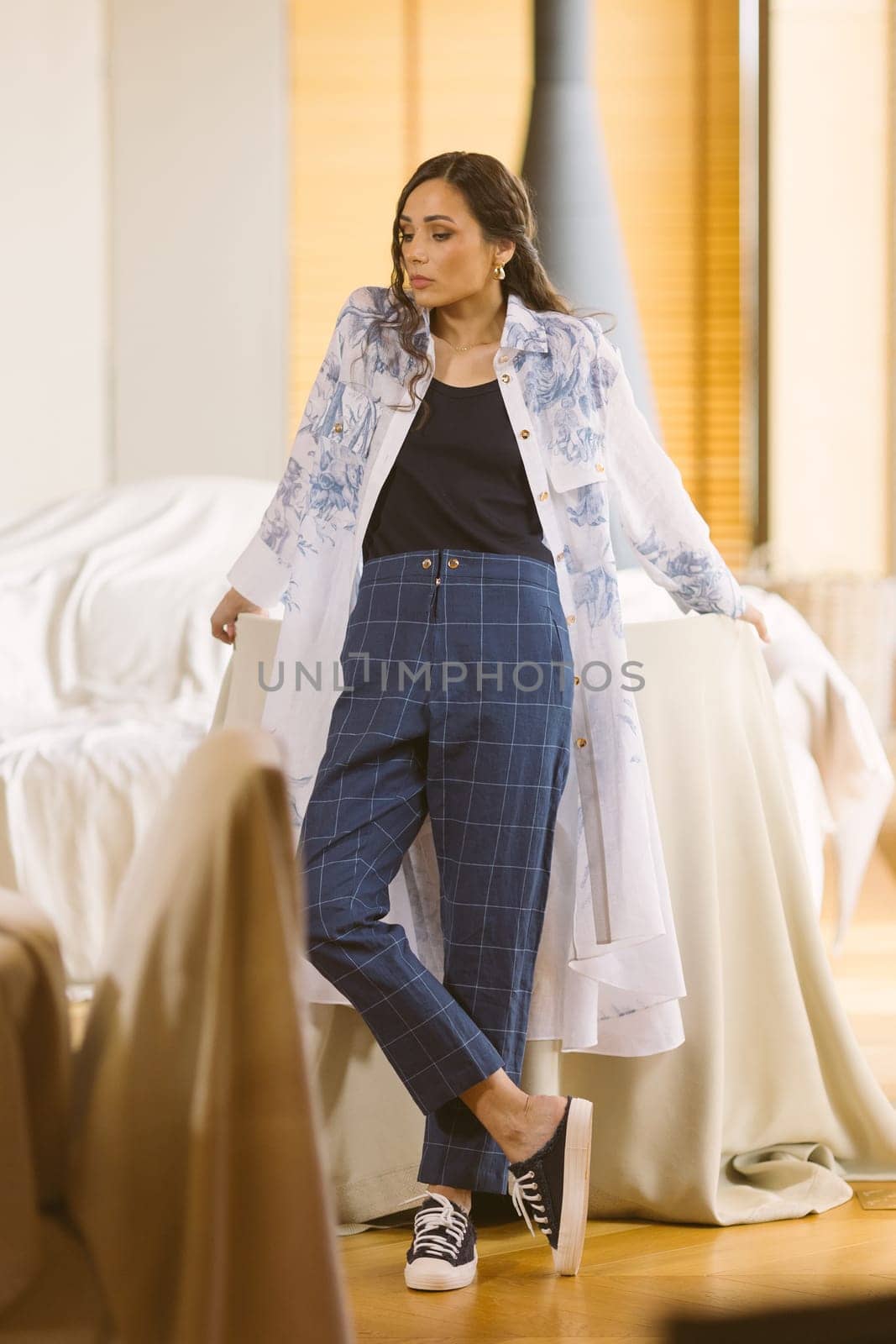Fashionable confident woman wearing elegant suit, trousers posing in interior. by sarymsakov