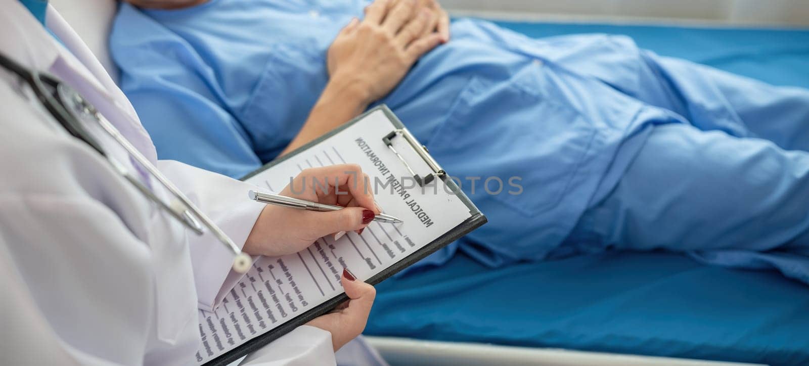 A female doctor is examining the body and taking notes on a sick person in a hospital examination room..