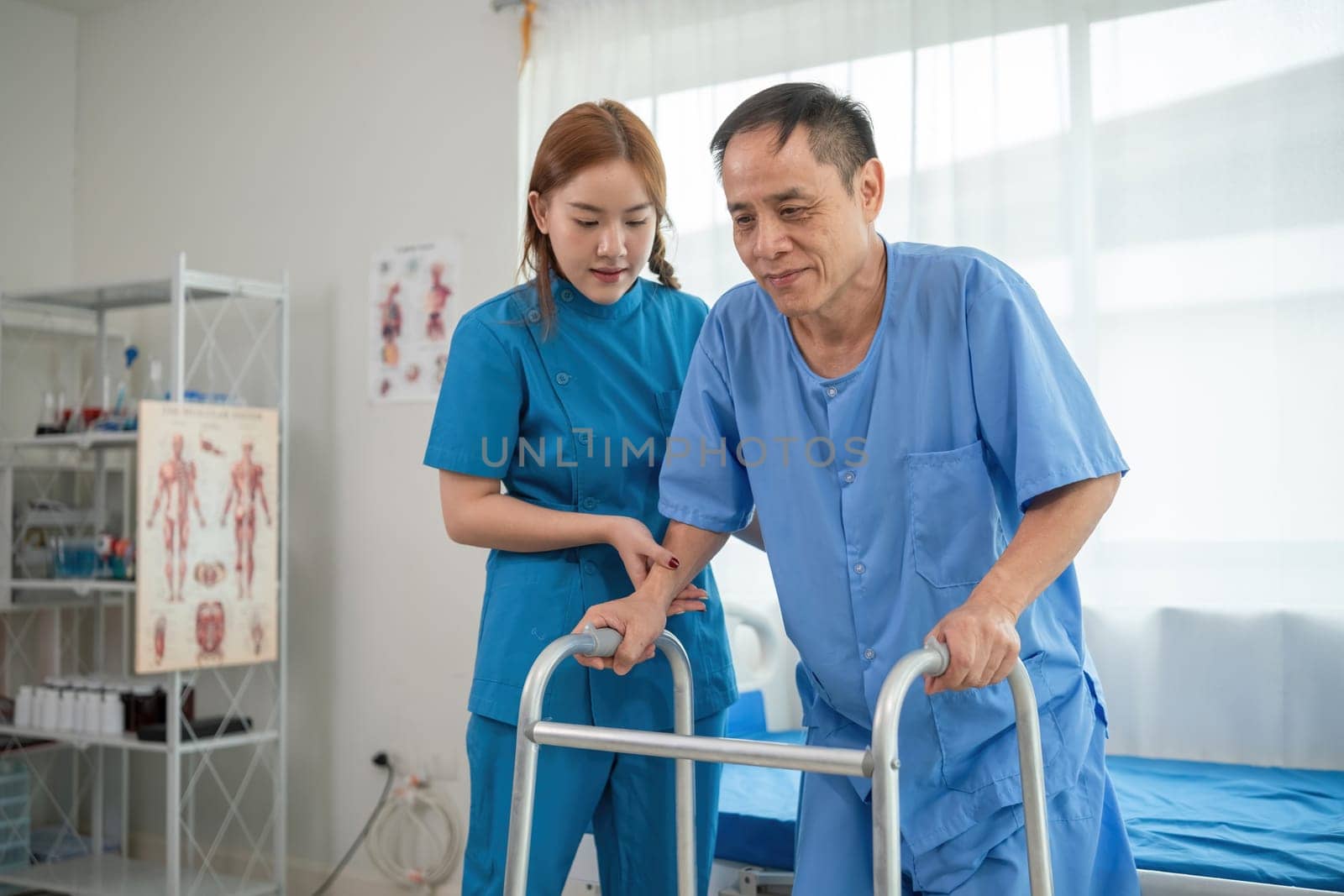 A sick caregiver or young nurse is helping a patient who is rehabilitating with physical therapy at the hospital. by wichayada