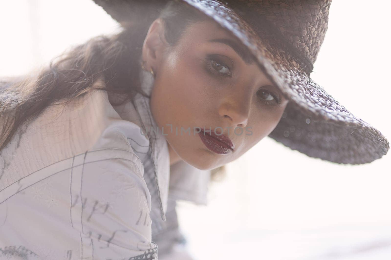 Indoor portrait of a young beautiful fashionable woman wearing stylish accessories. by sarymsakov