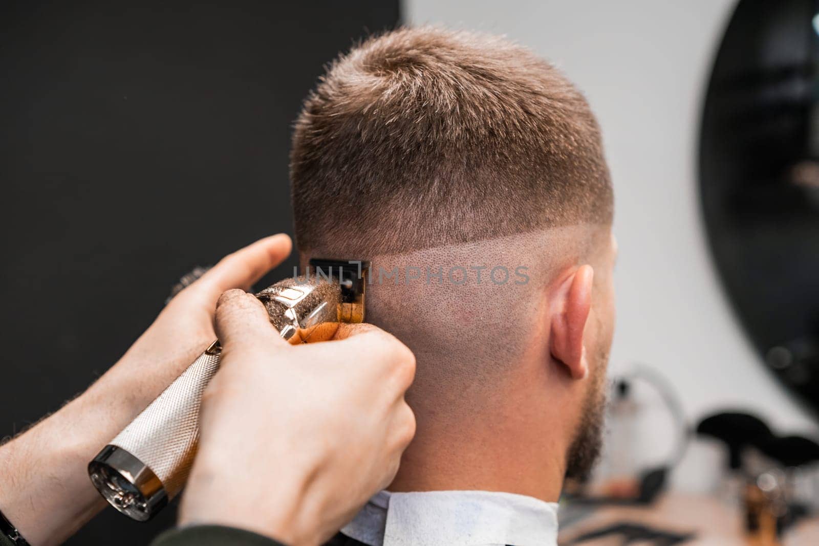 Shaving of male occiput by a hairdresser in the barbershop