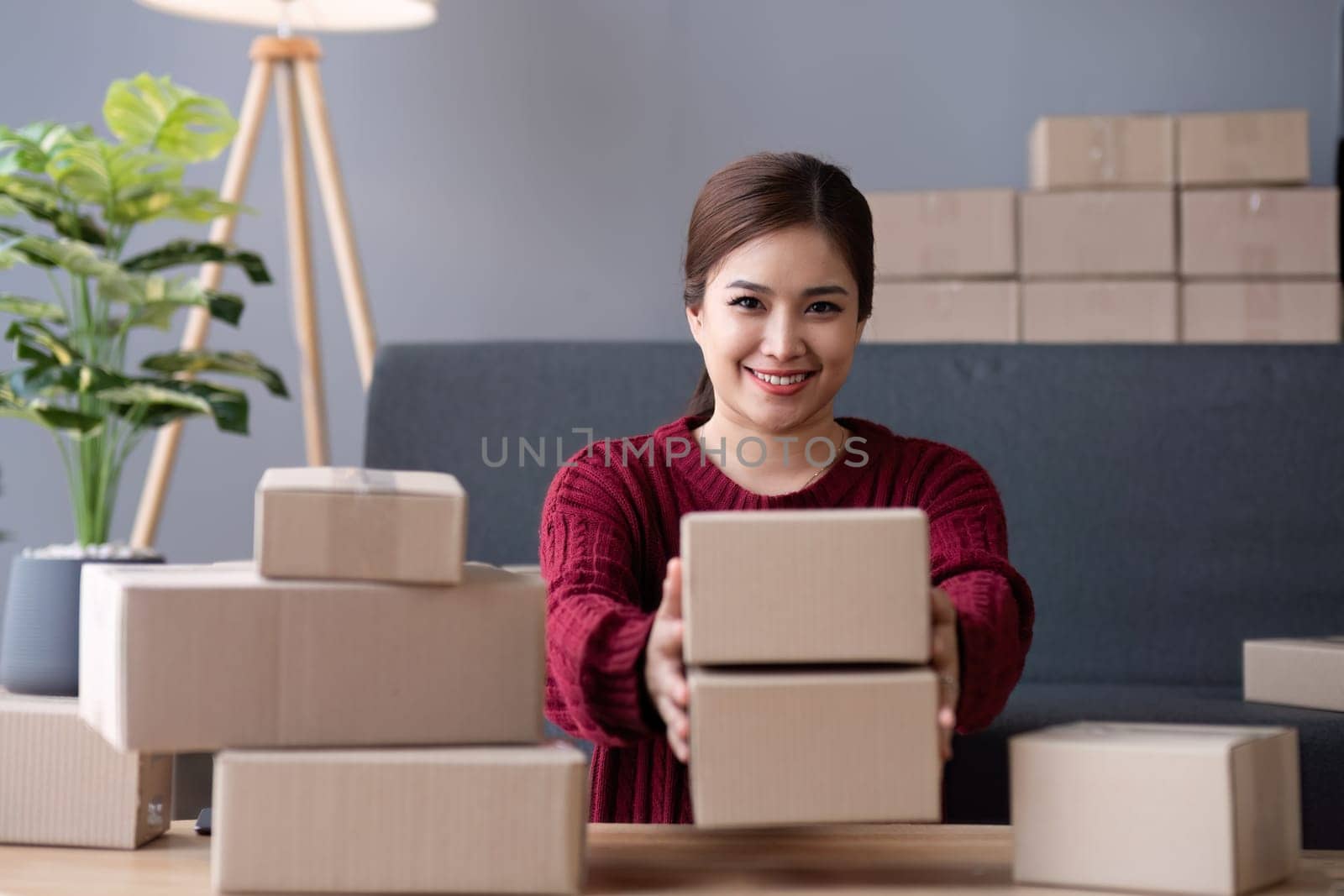SME business entrepreneurs small in asia Preparing cardboard boxes in home office Small business operators preparing to ship to customers by wichayada
