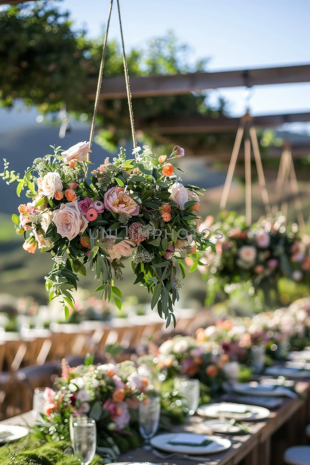 A table with a bunch of flowers hanging from the ceiling