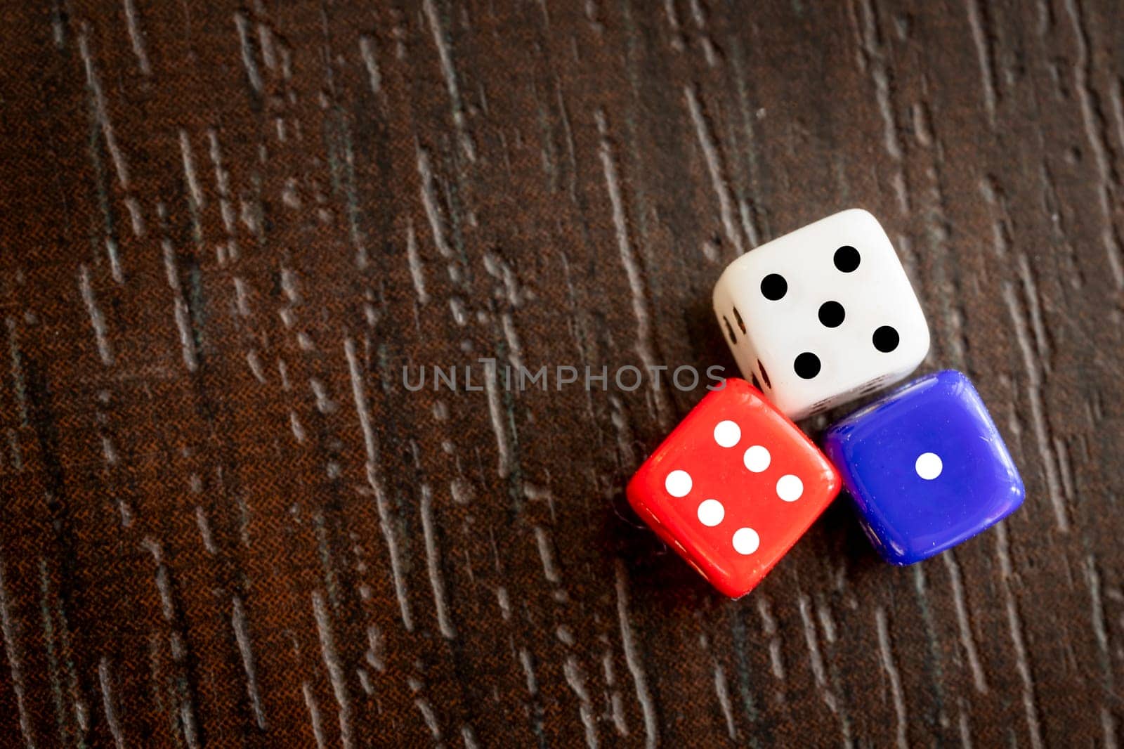 Dice Games With three colorful Dice on the table. View from above 