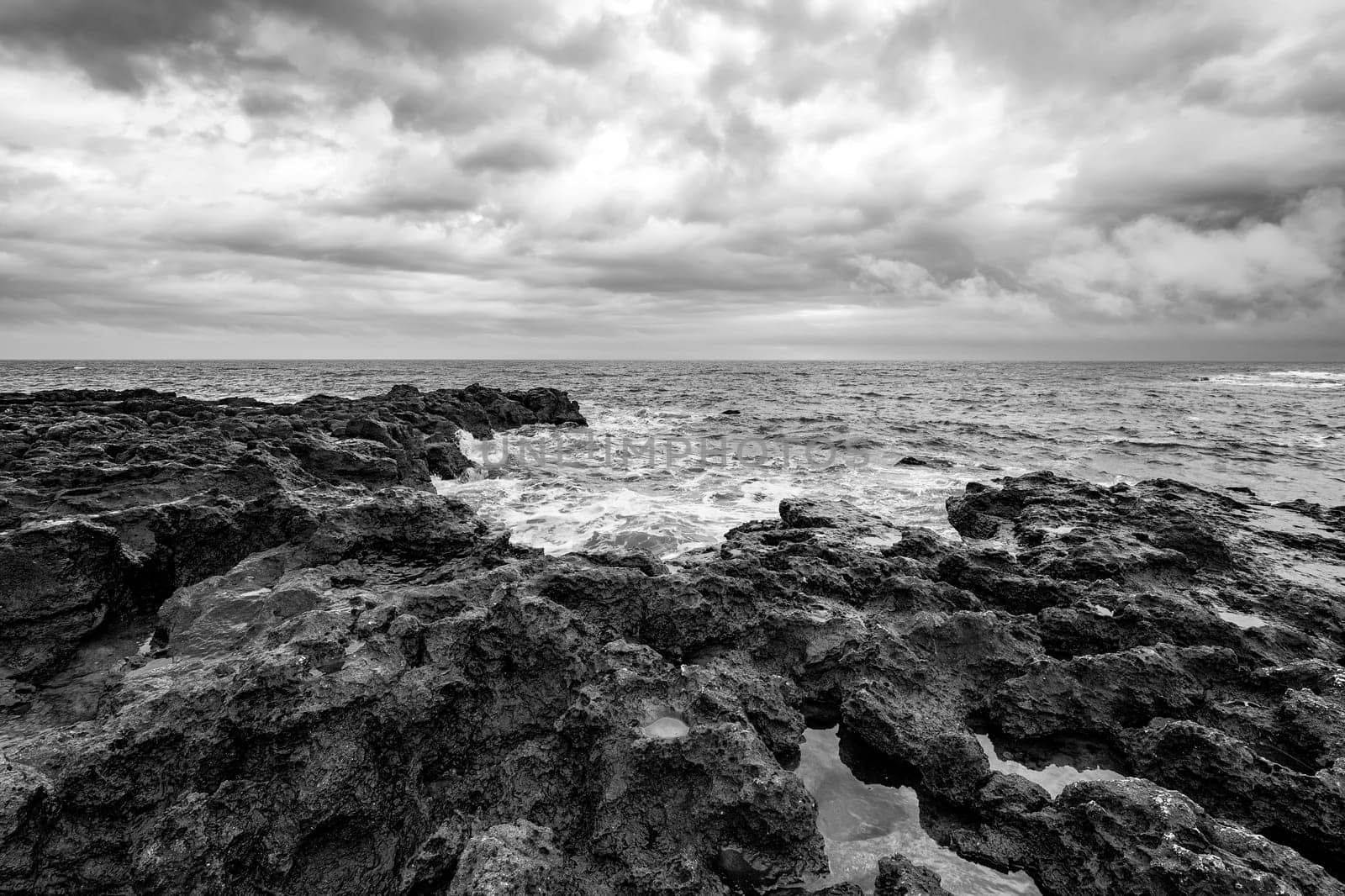 Amazing seascape with scenic clouds over the sea with rocky shore