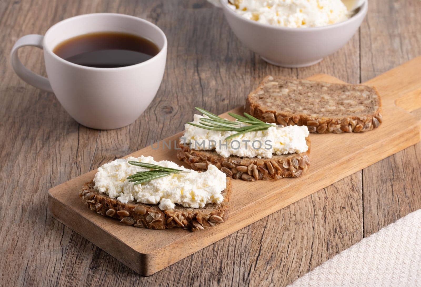Homemade rye bread with cottage cheese in a plate and coffee. Healthy breakfast concept by NataliPopova