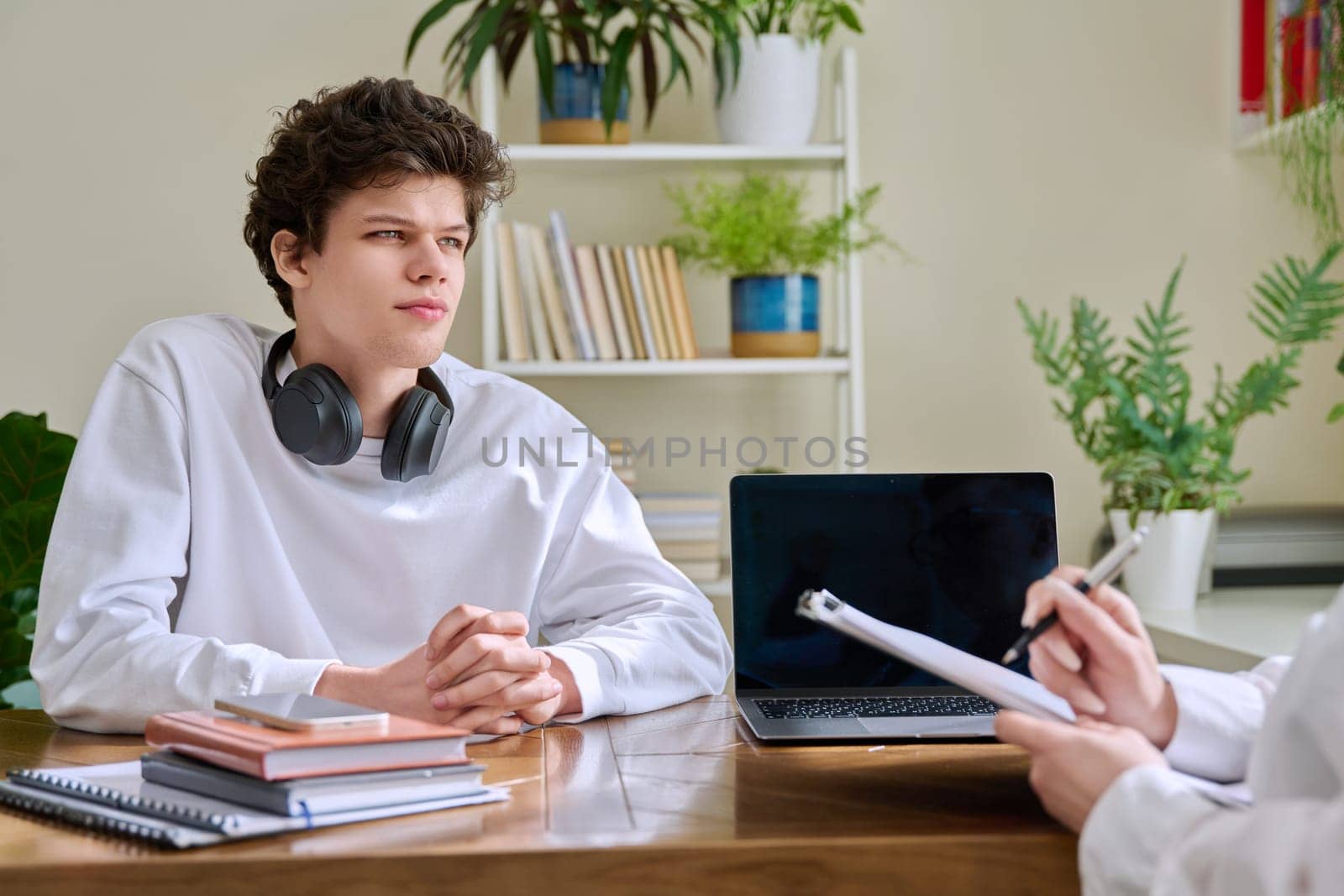 Young man university college student at meeting with female professional mental therapist, social worker, counselor, behavior. Psychology therapy help counseling treatment support, mental health