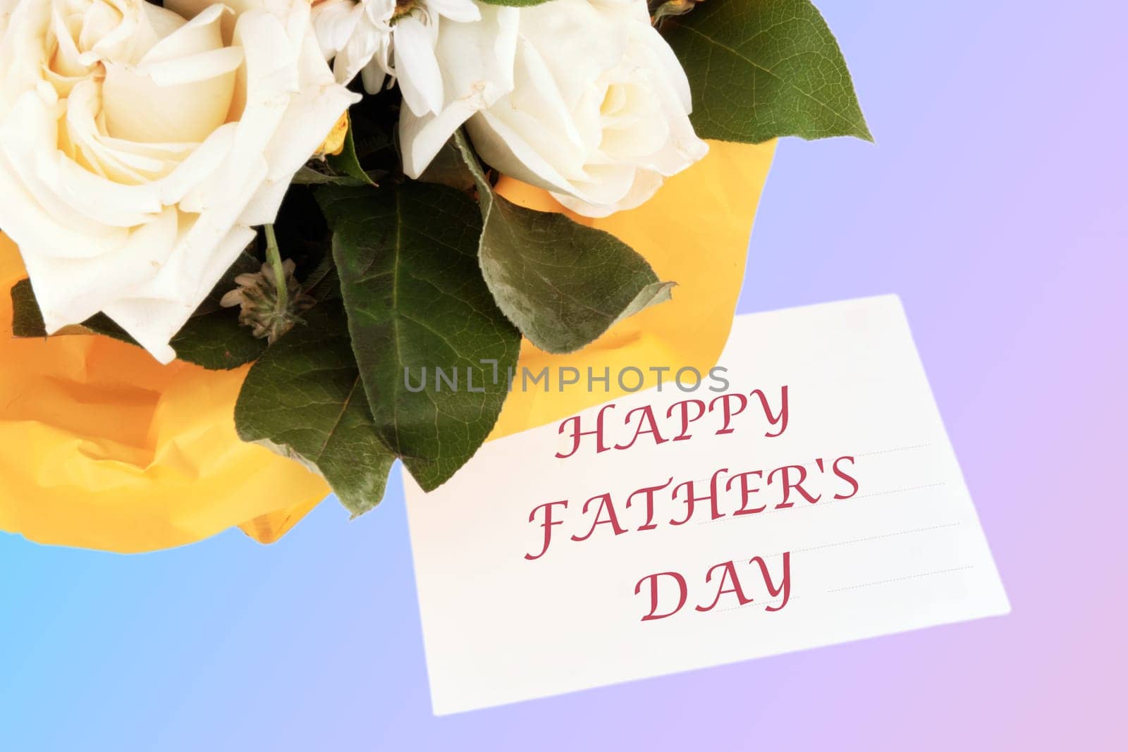 HAPPY FATHER'S DAY text on the card near the bouquet of flowers by Ihar